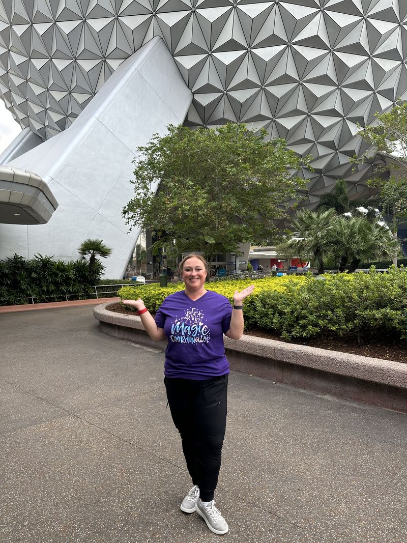 ’Chelle smiling in front of Spaceship Earth at EPCOT