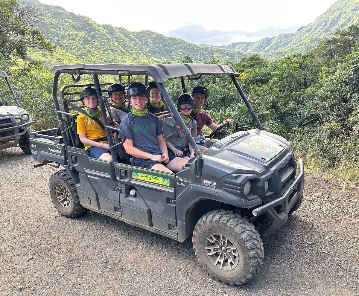 ’Chelle and her family on a UTV excursion through green hills in Hawaii