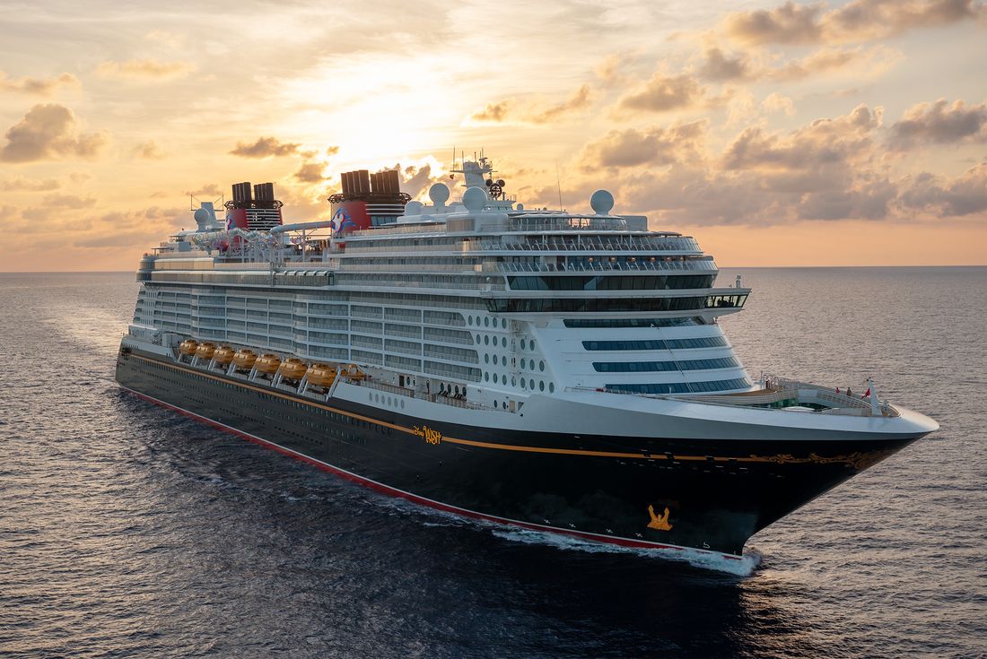 A Disney Cruise Line ship sailing at sunset