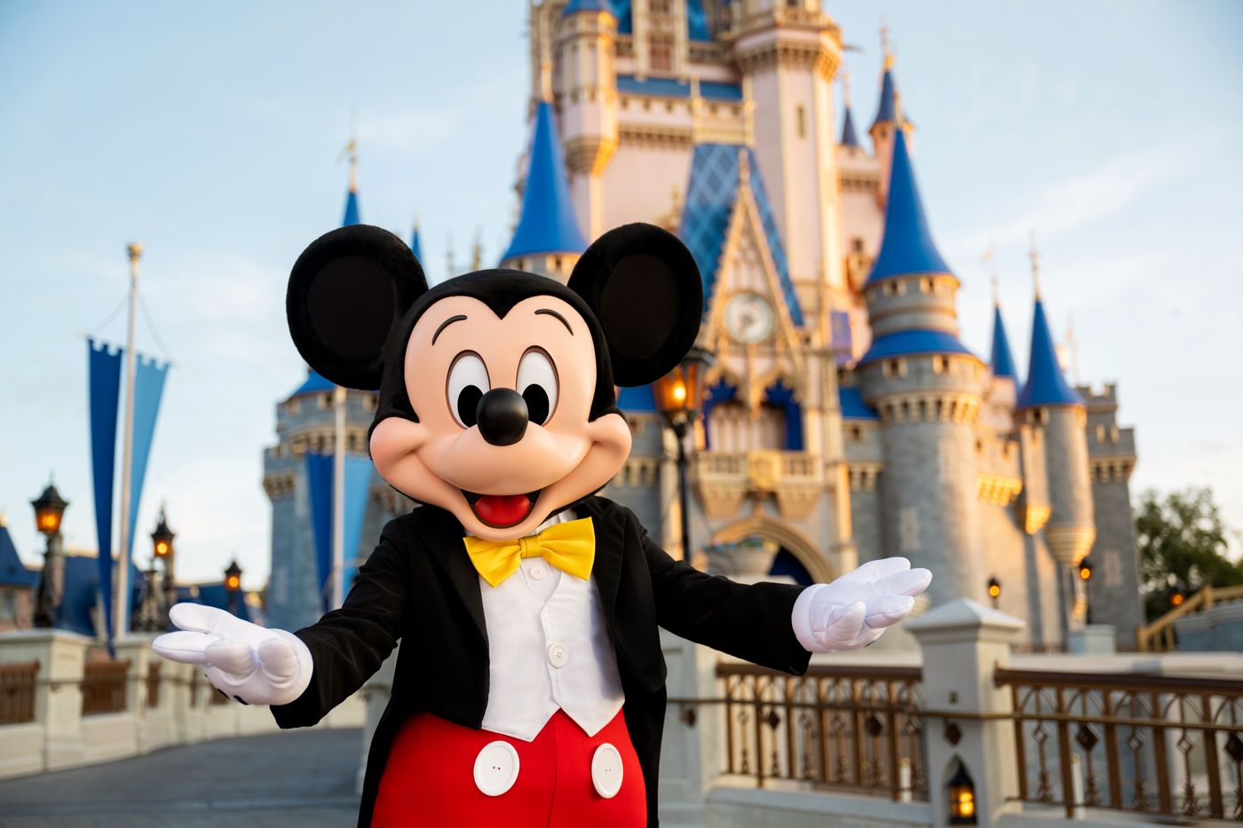 Mickey Mouse welcoming guests in front of Cinderella Castle at Walt Disney World